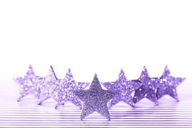 Textured glittering Ultra Violet stars on white background. Demonstration of color of the year. clipart