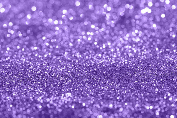 Glamour Ultra Violet sparkling background. Blured glitter background with blinking stars. Holiday abstract texture.