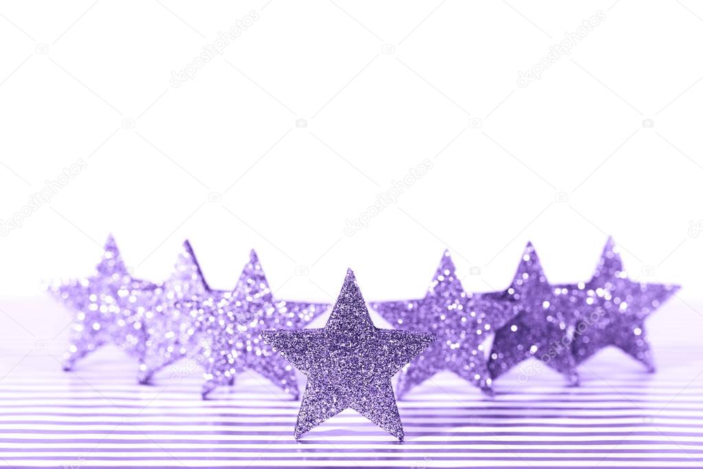 Textured glittering Ultra Violet stars on white background. Demonstration of color of the year.