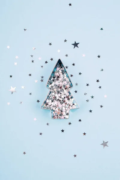 Christmas tree shape with sparkles on blue background, Christmas mood