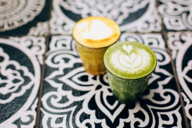 Trendy multicolored lattes with avocado and turmeric tastes clipart