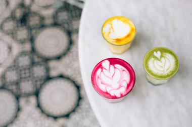 Trendy multicolored lattes with beetroot, avocado and turmeric tastes clipart