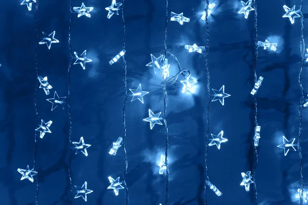 Silver garland on blue — Stock Photo, Image