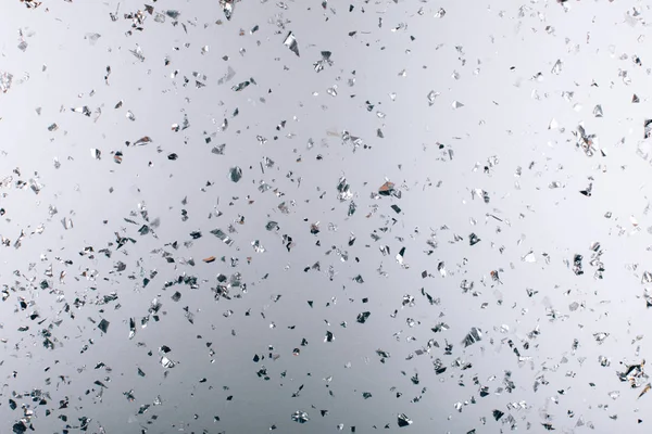 Silver falling confetti on metallic backdrop — Stock Photo, Image