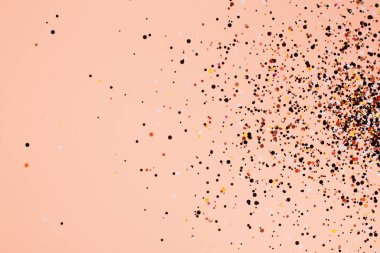Falling confetti on coral background