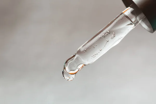 Pipette with drop of hyaluronic acid Stock Photo