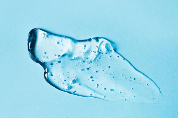 Smear of transparent gel on blue background. — Stock Photo, Image