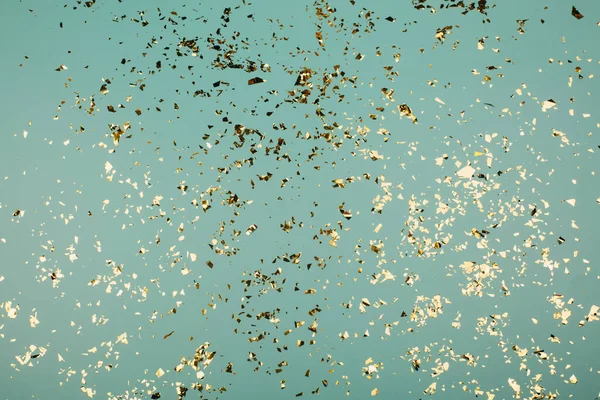 Golden flying sparkles on blue holiday background. — Stock Photo, Image