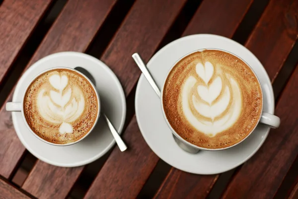 Två Vita Koppar Cappuccino Med Latte Konst Träbord — Stockfoto