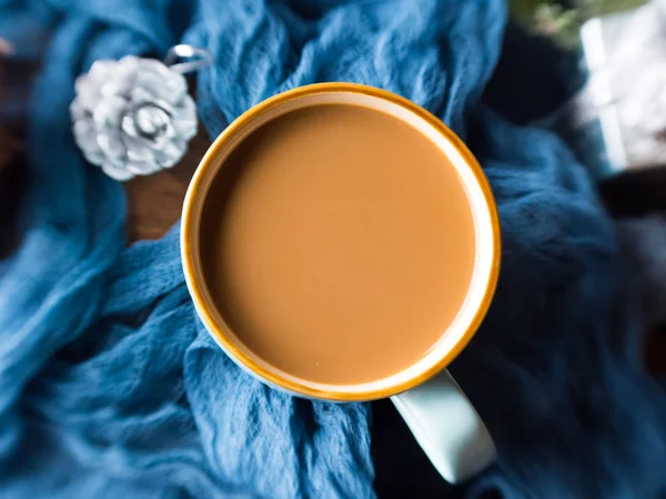 Mug of coffee and milk on dark winter background