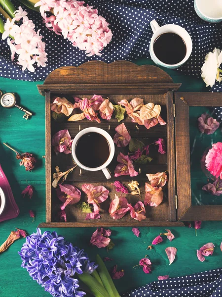 Coffee and flowers on dark background