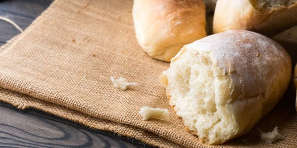 Versgebakken brood op jute donkere houten achtergrond — Stockfoto