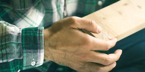 Man crafting glue wooden object with hands. Lifestyle process