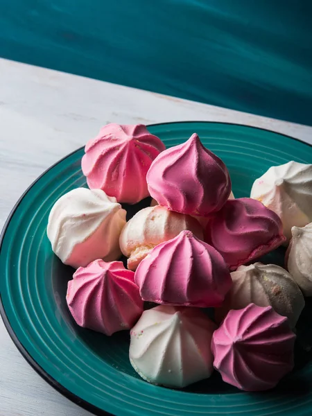 Pastel color meringue on green — Stock Photo, Image