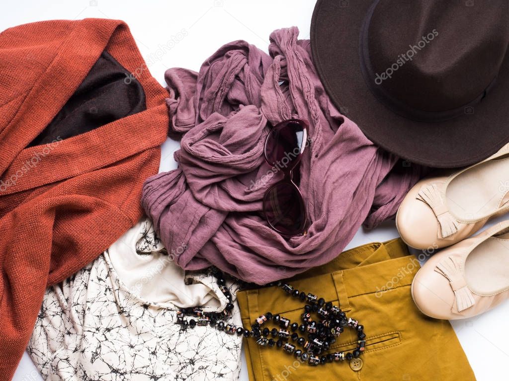 Flat lay with womans autumn clothes, glasses hat