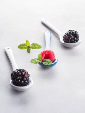 Üzerinde gri arka plan üzerine kaşık taze çilek