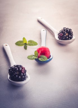 Üzerinde gri arka plan üzerine kaşık taze çilek