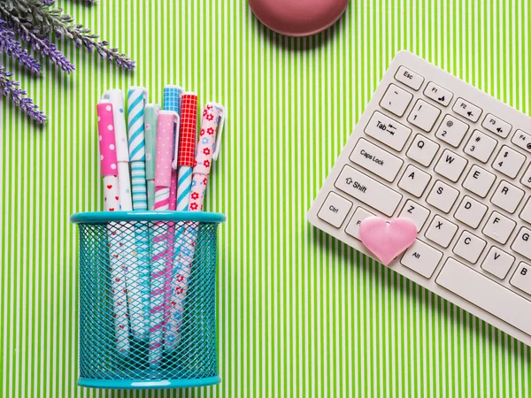 Colorful pens and keyboard. Pastel flat lay