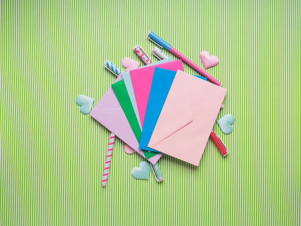 Colorful pens and envelopes. Pastel flat lay
