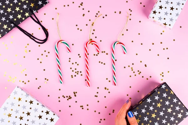 Christmas flat lay frame on pink with candy canes — Stock Photo, Image