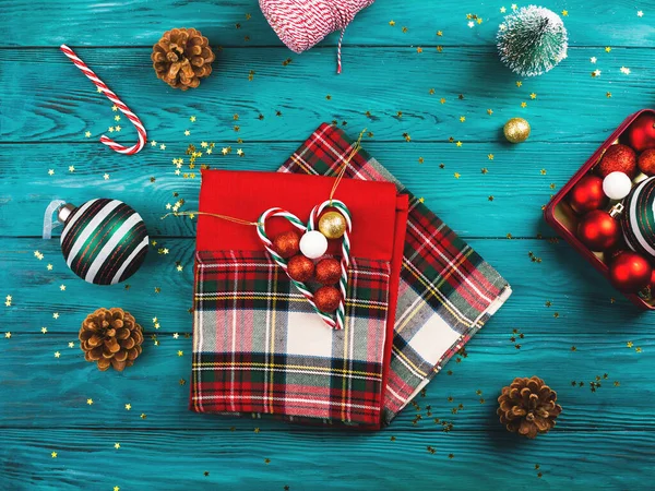 Christmas ornament and red napkins on green table