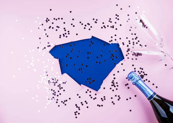 Fundo azul rosa com confete e champanhe — Fotografia de Stock
