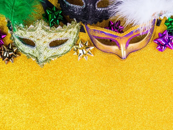 Colorful mardi gras carnival masks on golden — Stok fotoğraf