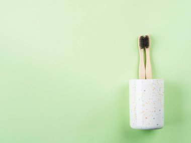 Bamboo toothbrushes for two in ceramic glass