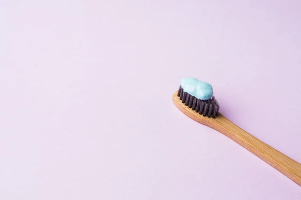 Bamboo toothbrush on pink pastel background — Stock Photo, Image