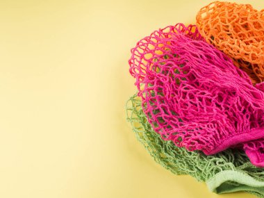 Sarı arkaplanda yeniden kullanılabilir pamuk ağları.