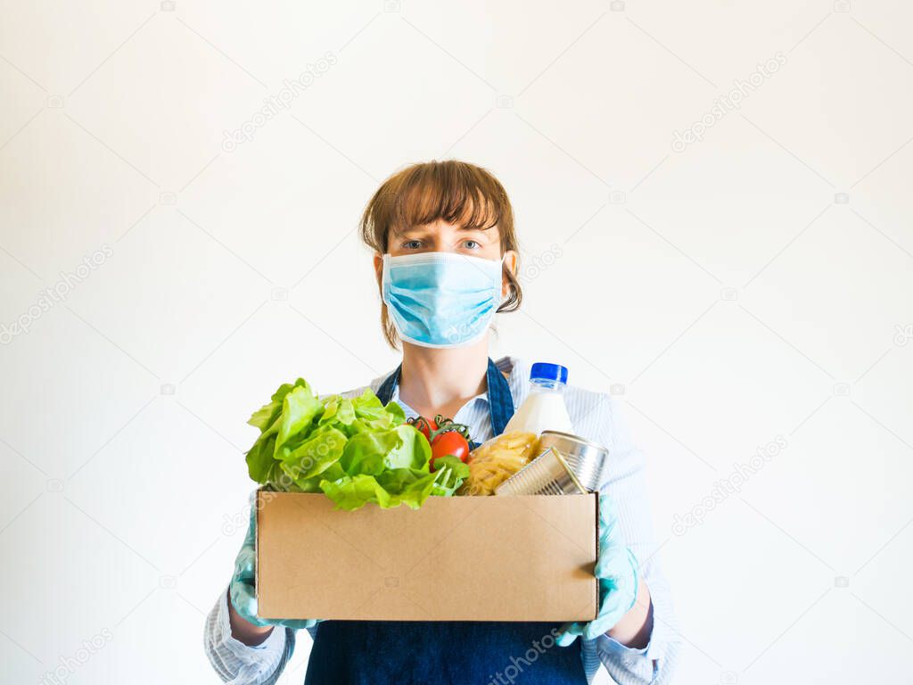 Woman in blue in face mask with food delivery box