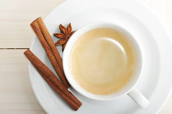 Xícara de café e pires, canela e anis estrela — Fotografia de Stock