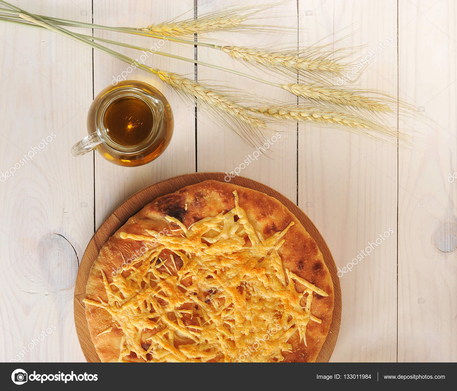 Tortilla bread with cheese, a pitcher of olive oil and wheat ear Stock