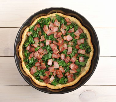 quiche, spinach and bacon in the baking dish  clipart
