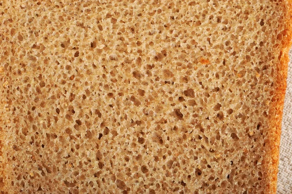 Background of slice of bread - black rye bread with yeast — Stock Photo, Image