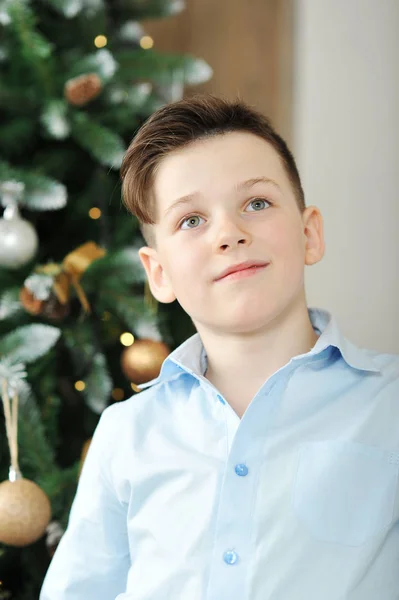 Cute boy in blue shirt with blue eyes looking with admiration — Stock Photo, Image