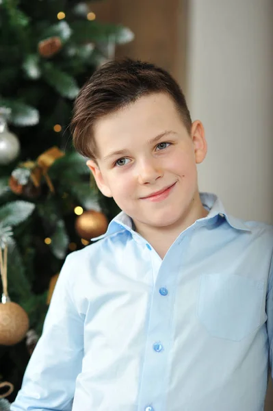 Cute boy in blue shirt with blue eyes dreams about the Christmas — Stock Photo, Image