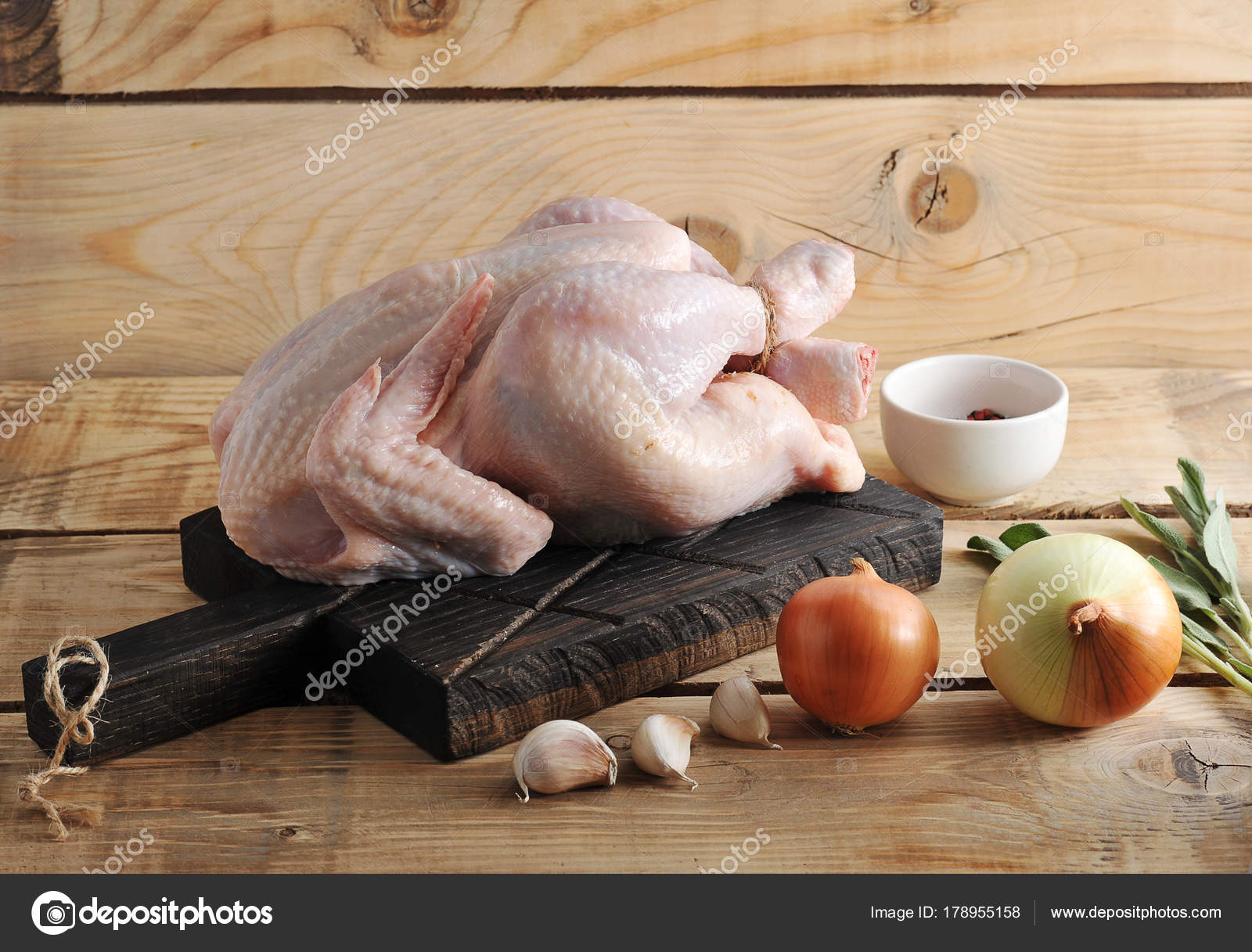 Whole raw chicken carcass on the Board and spices Stock Photo by