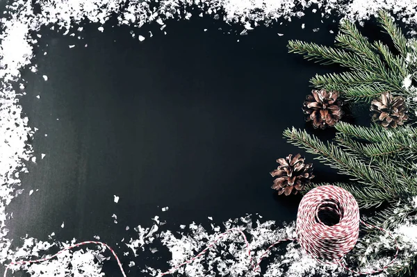 background for new year greetings - tree branches, cones and sno