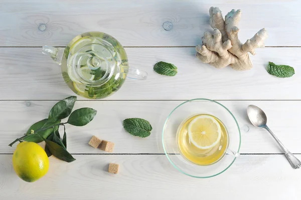 Tea with lemon, ginger and mint in a glass Cup, teapot and tea s — Stock Photo, Image