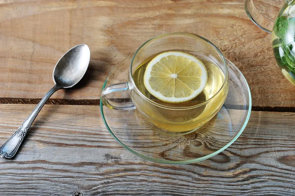 Glass mug of tea with ginger and slice of lemon — Stock Photo, Image