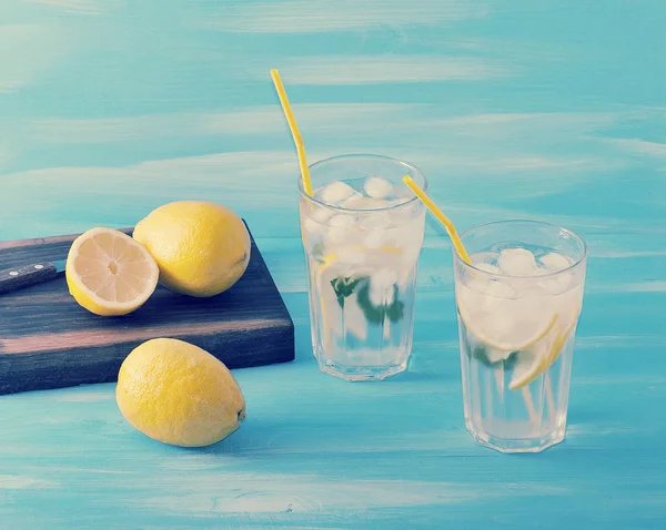 Homemade lemonade - lemon, mint, ice and water in glasses — Stock Photo, Image