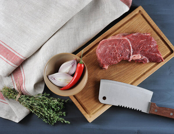 piece of raw beef on a wooden Board