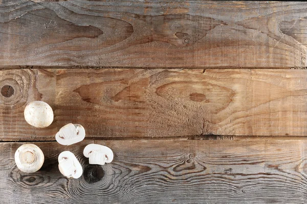 Fresh white mushrooms champignon on rustic wooden background — Stock Photo, Image