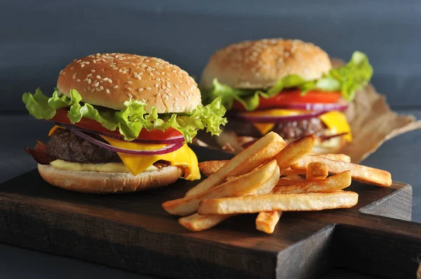 Burger with fries on wooden rustic Board — Stock Photo, Image