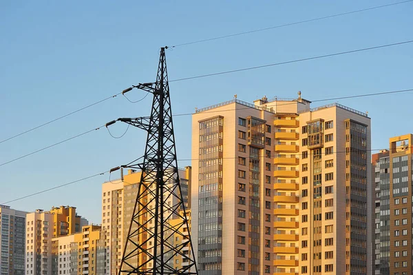 power line support on the background of new residential buildings in Saint Petersburg, Russia