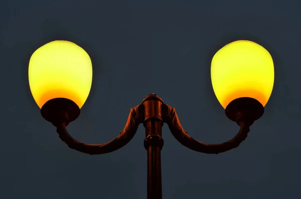 Gece karanlık gökyüzüne karşı aydınlatılmış sokak lambası — Stok fotoğraf