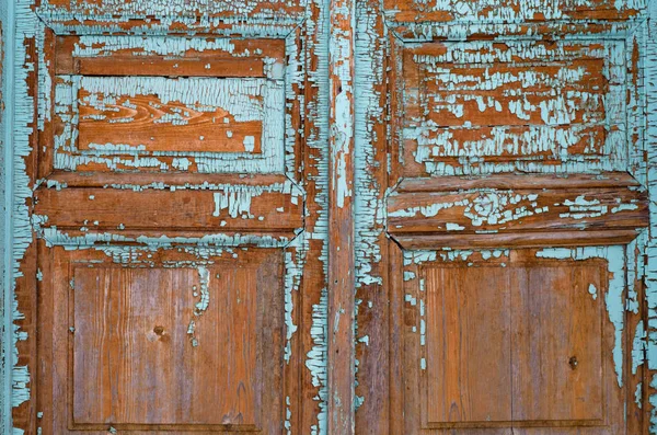 Close-up of an old wooden door with blue peeling paint — Stock Photo, Image