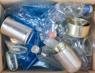 Plastik, cam şişeler ve çelik kutularla dolu çöp kutusunu kapat. .