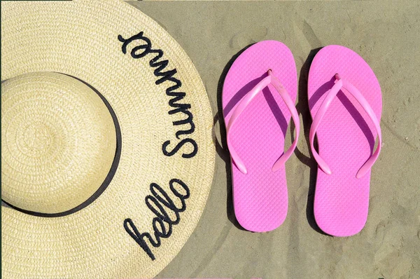 Close-up vysoký úhel pohledu na slaměný klobouk s ručně psaným textem "ahoj léto" přes a plážový swing na pláži písek . — Stock fotografie